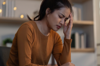 Woman experiencing emotional stress during a counselling moment at home.