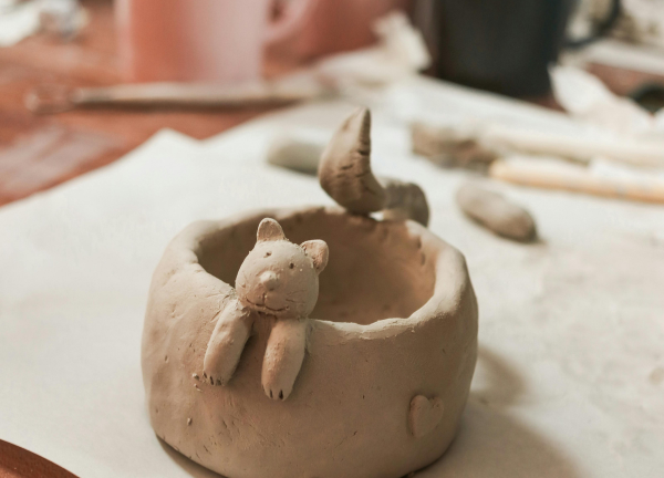 Handmade clay pot with a cute animal sculpture created during Iyali’s Clay Art and Pottery Workshop in Chennai.