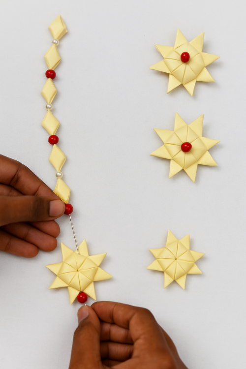 Hand weaving palm leaf strips with beads to create lightweight handmade jewellery at Iyali’s Palm Leaf Jewellery Workshop in Chennai.